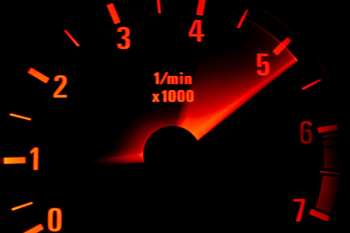 Backlit tachometer with the needle sweeping up past 5,000 rpm